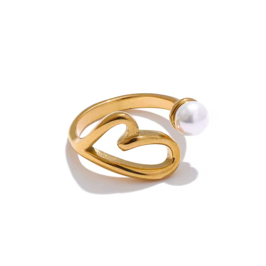 A stainless steel adjustable ring featuring a hollow heart design with a lustrous pearl accent. Available in gold and silver, this elegant ring adds a timeless touch to any look.