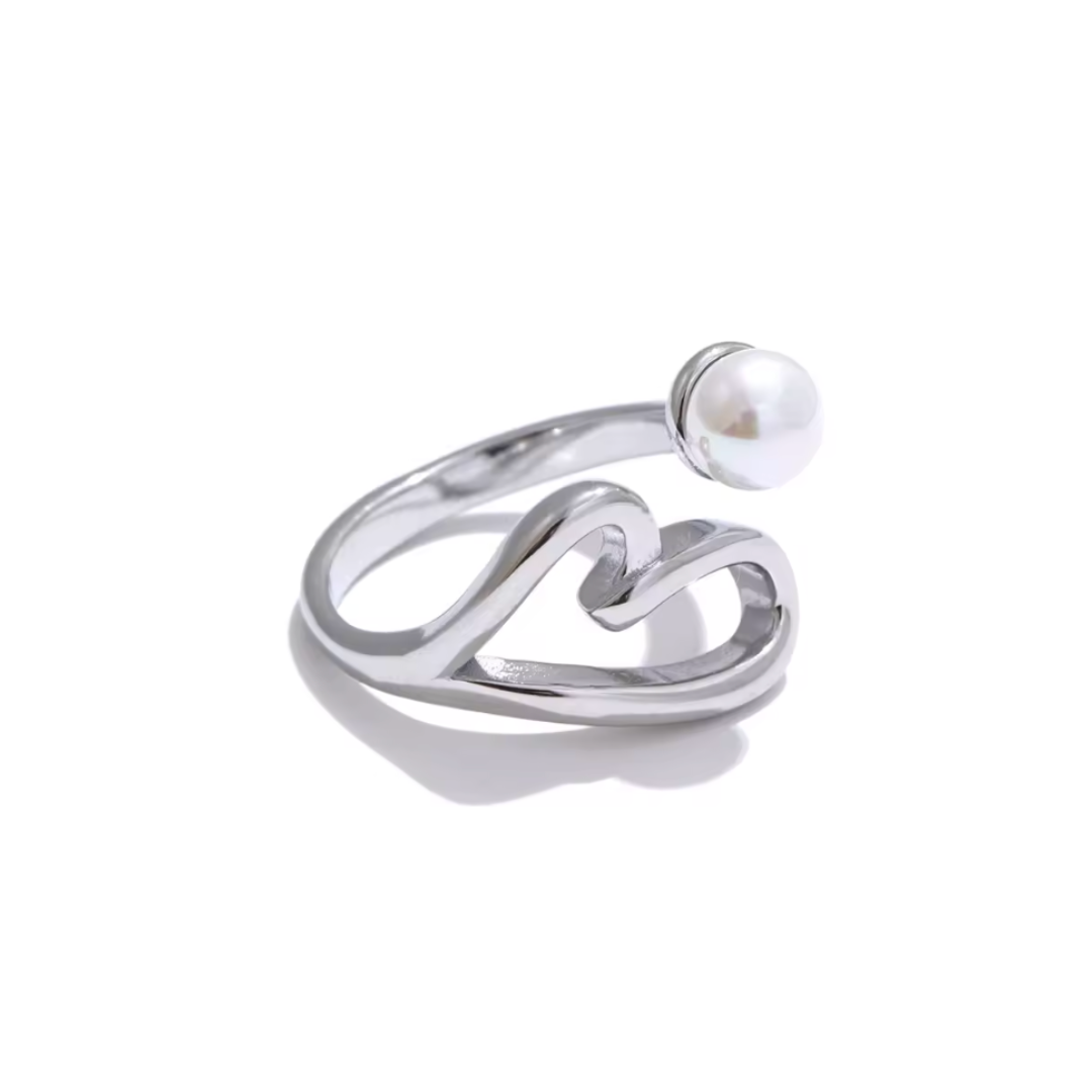 A stainless steel adjustable ring featuring a hollow heart design with a lustrous pearl accent. Available in gold and silver, this elegant ring adds a timeless touch to any look.