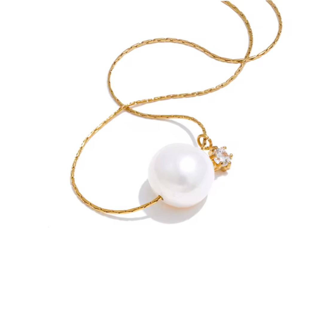 A gold stainless steel necklace with a luminous freshwater pearl and sparkling zircon pendant, offering a tarnish-resistant, timeless design for effortless elegance.