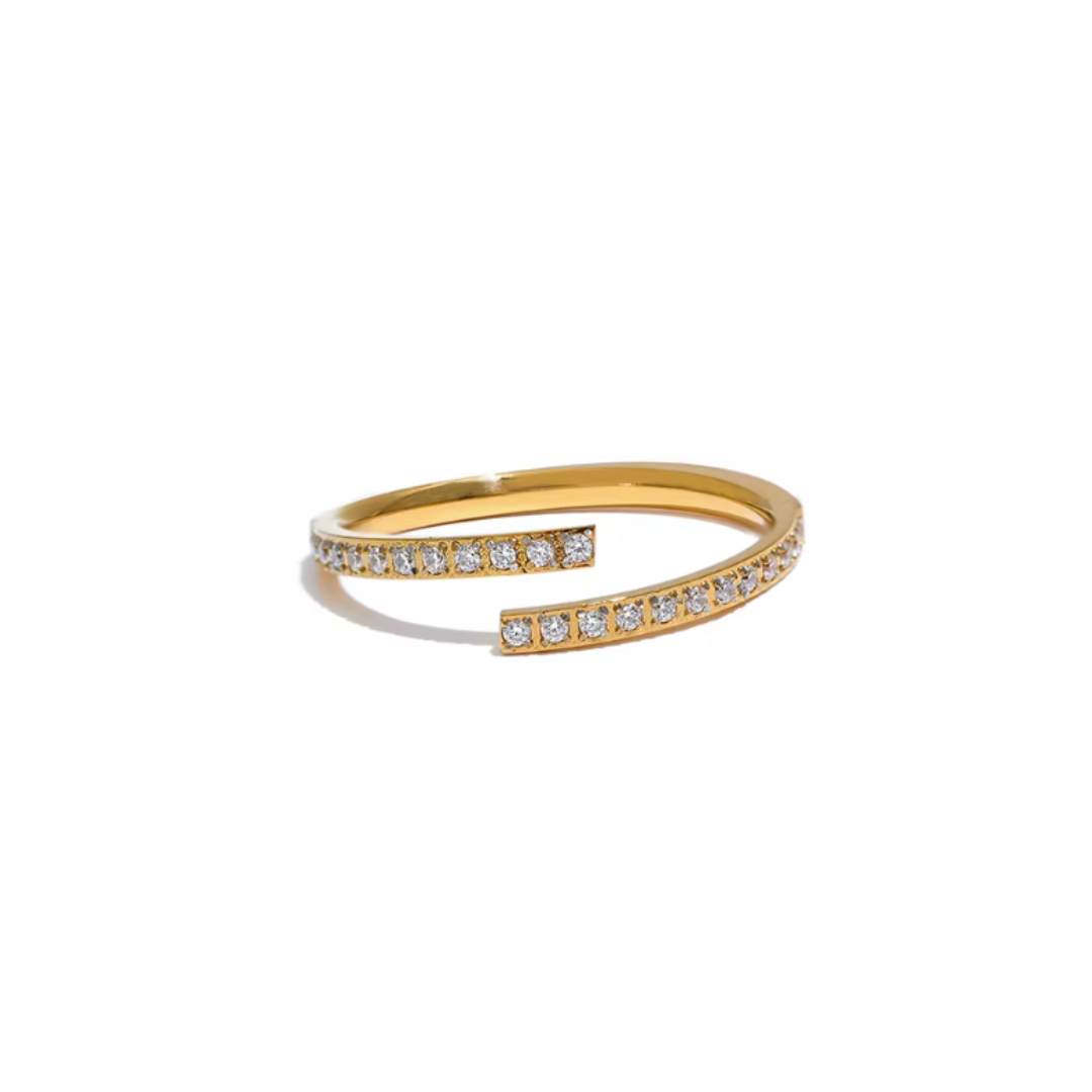 A golden minimalist open ring made of stainless steel, featuring a sparkling cubic zirconia stone. The sleek design offers an adjustable fit and is waterproof, perfect for adding a touch of elegance to any look.