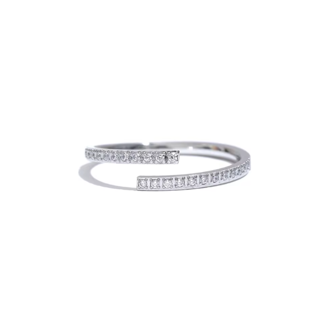 A Silver minimalistic open ring made of stainless steel, featuring a sparkling cubic zirconia stone. The sleek design offers an adjustable fit and is waterproof, perfect for adding a touch of elegance to any look.